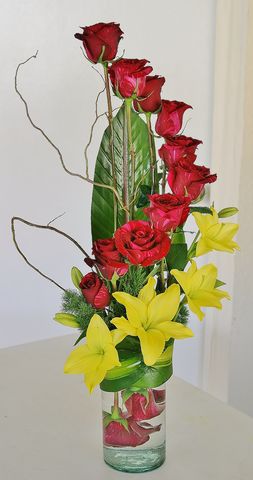 16 rosas y lilis en base de vidrio